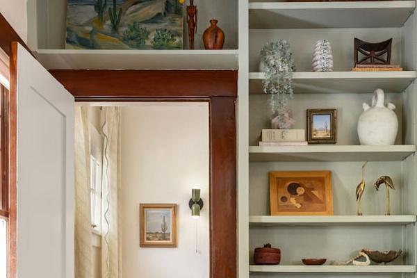 dining room shelves with door to 3rd bedroom nook.