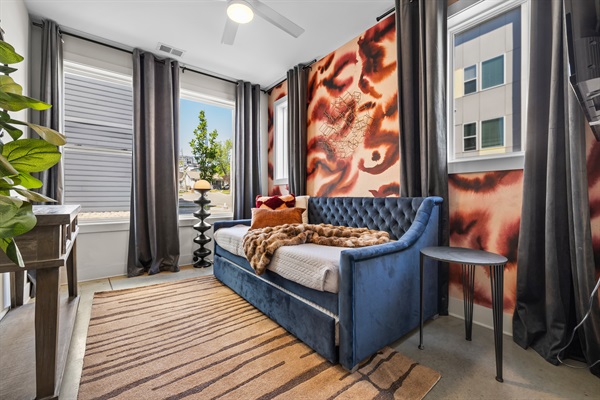 Chic Retreat: Bright room with bold decor, plush seating, and urban views for a vibrant stay!