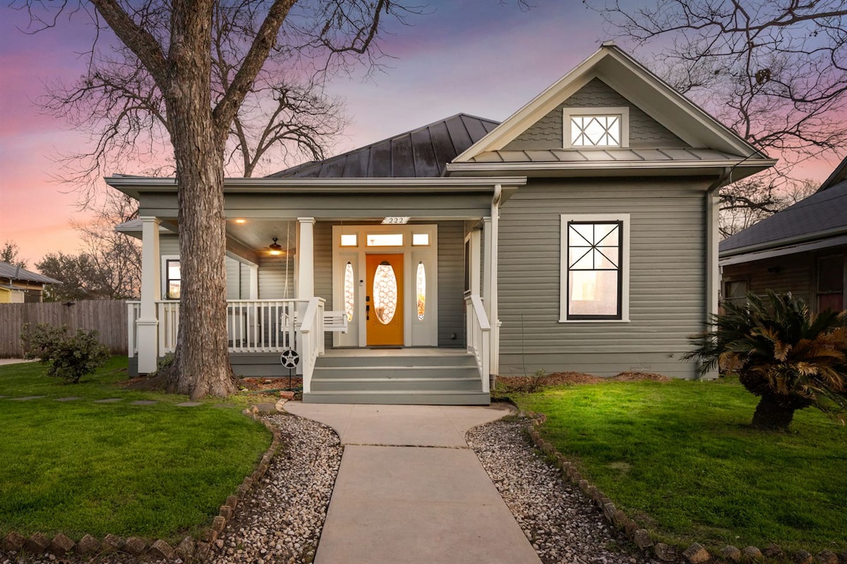 As dusk settles, our home glows with the promise of peaceful evenings under a sky painted with sunset hues.