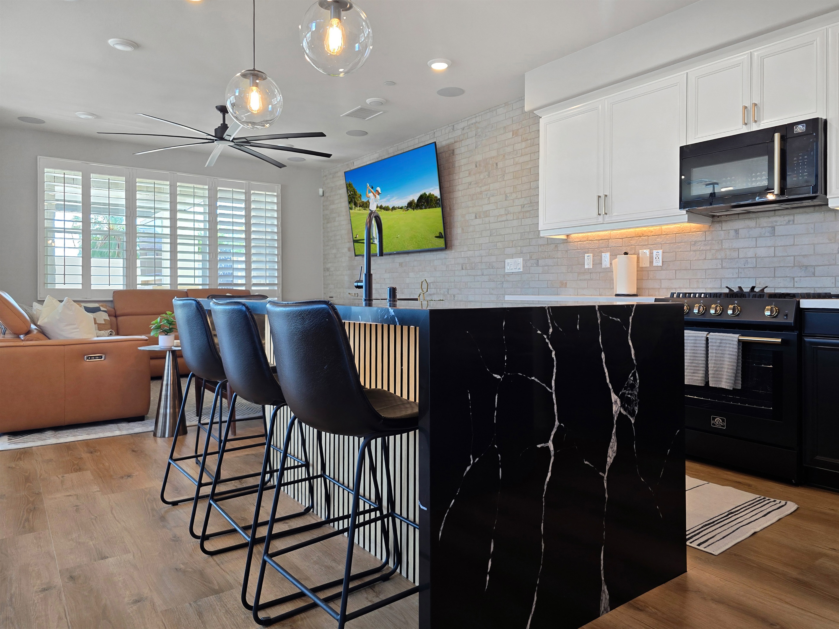 The kitchen's island has a custom waterfalled quartz counter.