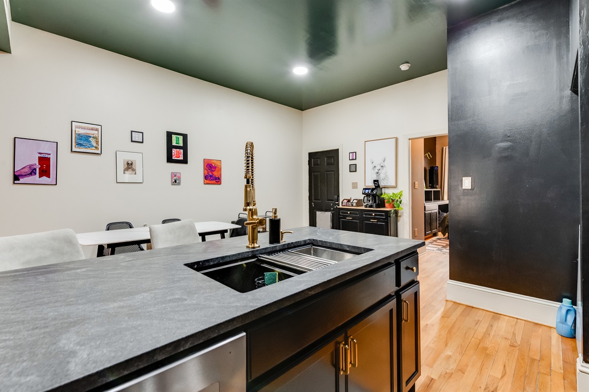 Kitchen: Modern design with sleek finishes, vibrant art, and spacious dining options!