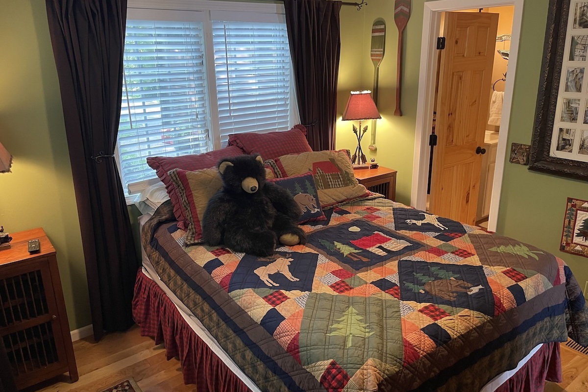 Main Floor Bedroom - Queen Bed. Bedroom is accessible to Main Floor Bathroom with shower, sink and toilet.