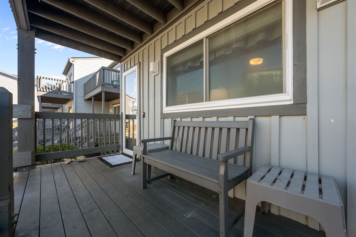 Covered deck with a cozy bench: perfect for a quiet morning coffee, winding down after the beach, or enjoying the coastal breeze in the shade