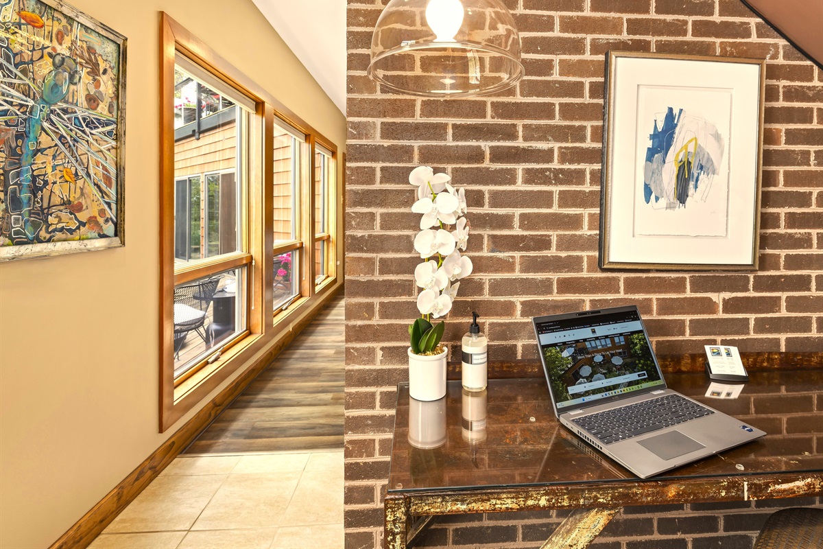 Tucked under the stairs with a lot of headroom and a garden view out the glass door to the left, pretty great place to work! Plus Cat 5, supplies, and task chair all await.