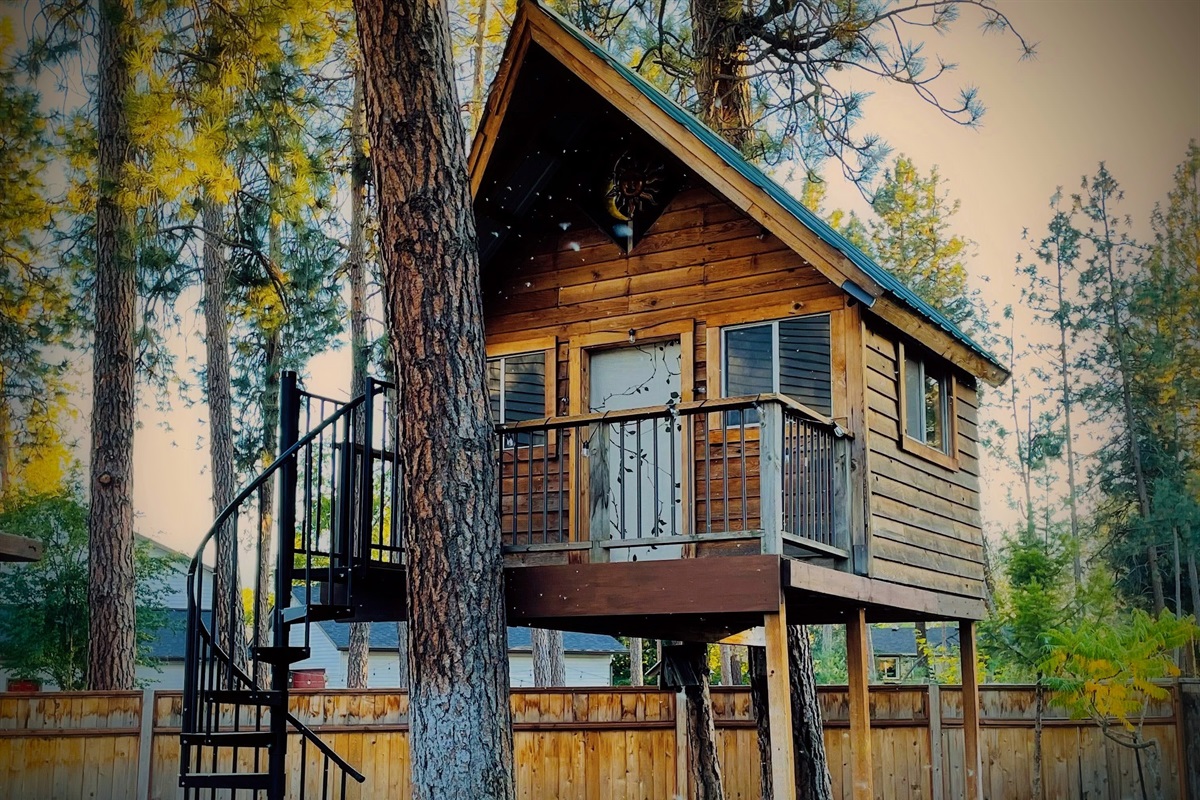 Cozy backyard treehouse is captivating for the young at heart.