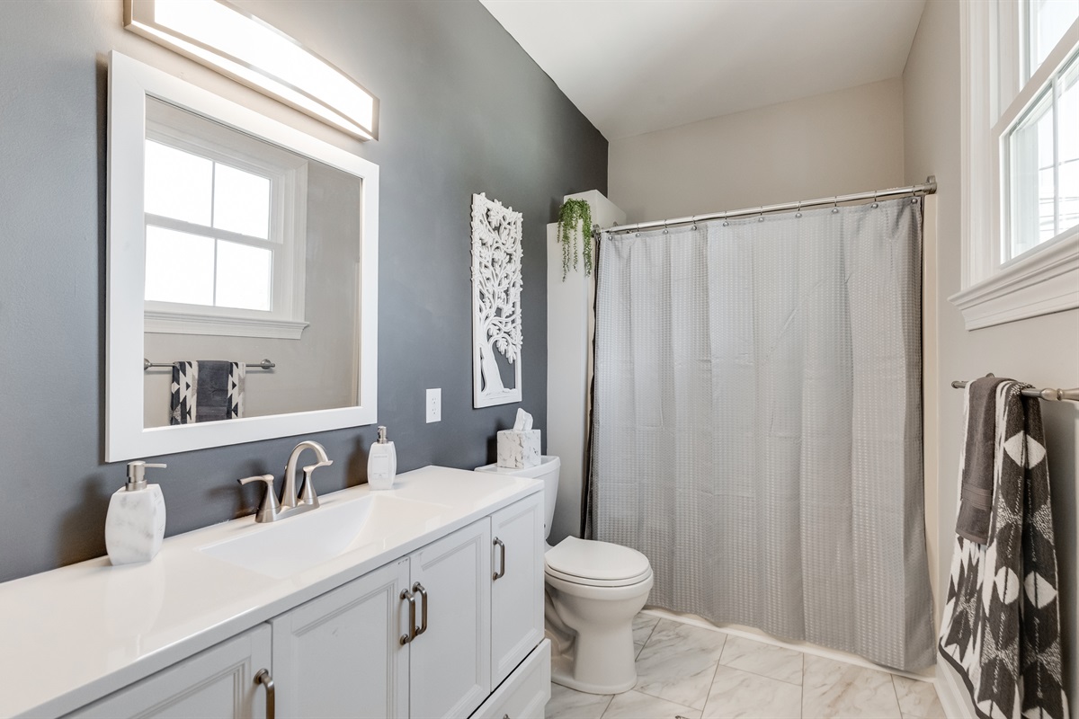 Bathroom 1 (Hallway): Modern finishes and bright natural light create a refreshing space for relaxation!