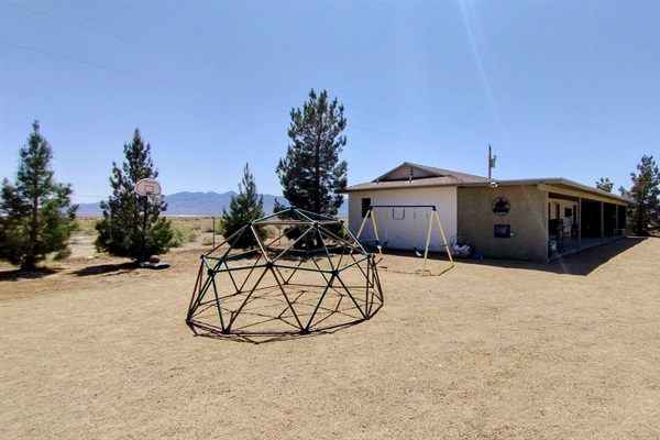 Fun play area for kids with a climbing dome, swings, basketball hoop, chalkboard, cattle roping lasso practice and more!!!