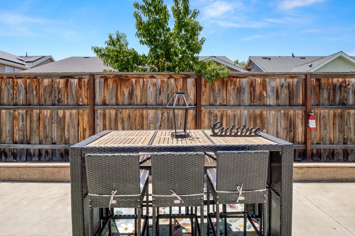 Gather around the outdoor dining table and enjoy meals together in your private backyard retreat. With comfortable seating and plenty of space, it's perfect for everything from morning coffee to evening dinners.