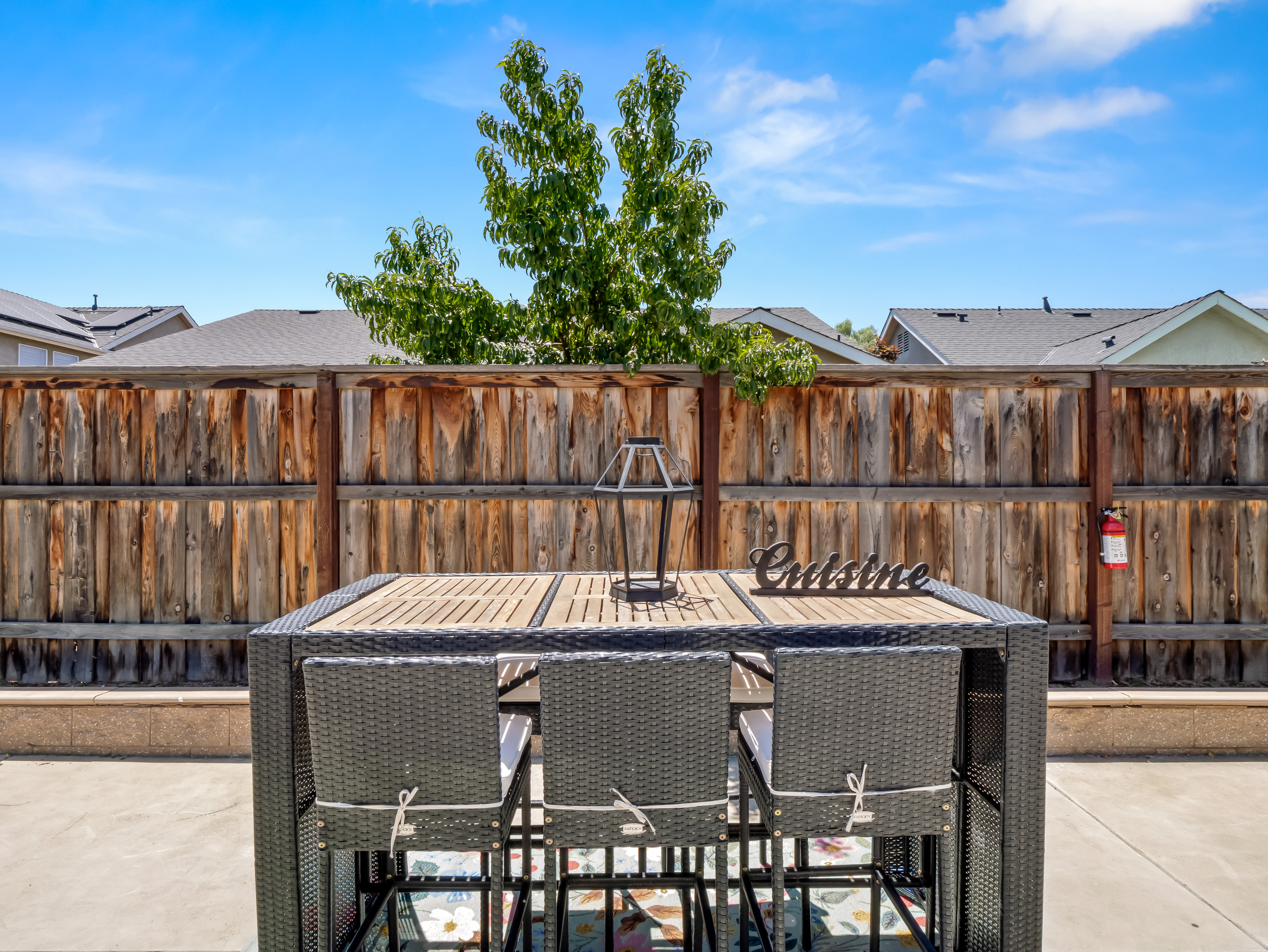 Gather around the outdoor dining table and enjoy meals together in your private backyard retreat. With comfortable seating and plenty of space, it's perfect for everything from morning coffee to evening dinners.
