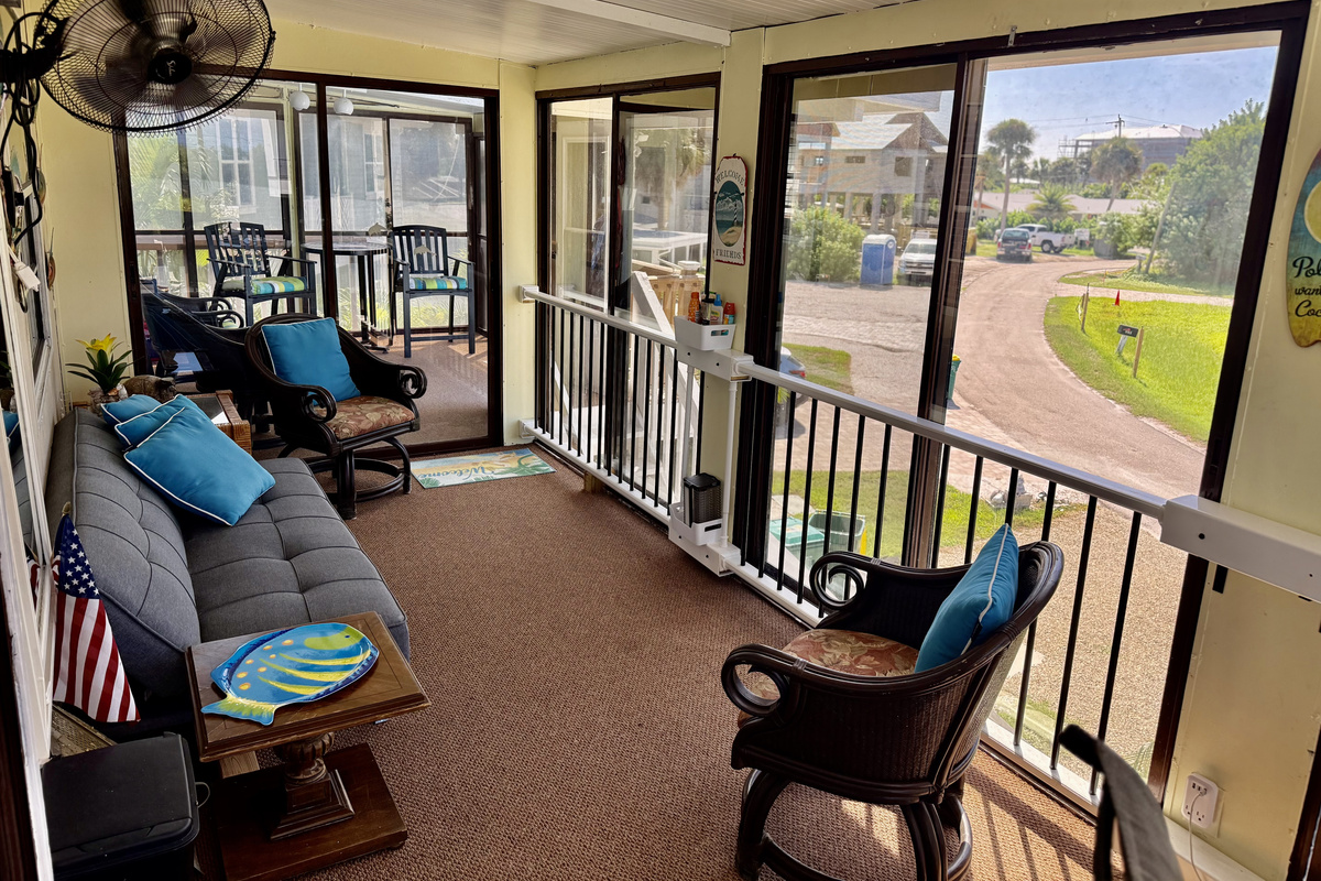 Large private second floor lanai with seating and outdoor desk with computer to work from home.
High Tide