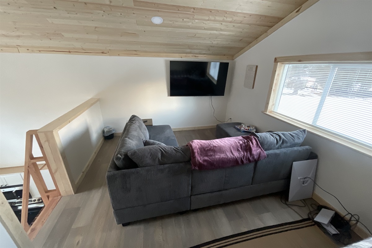 Loft living area - sectional sofa and big screen TV.