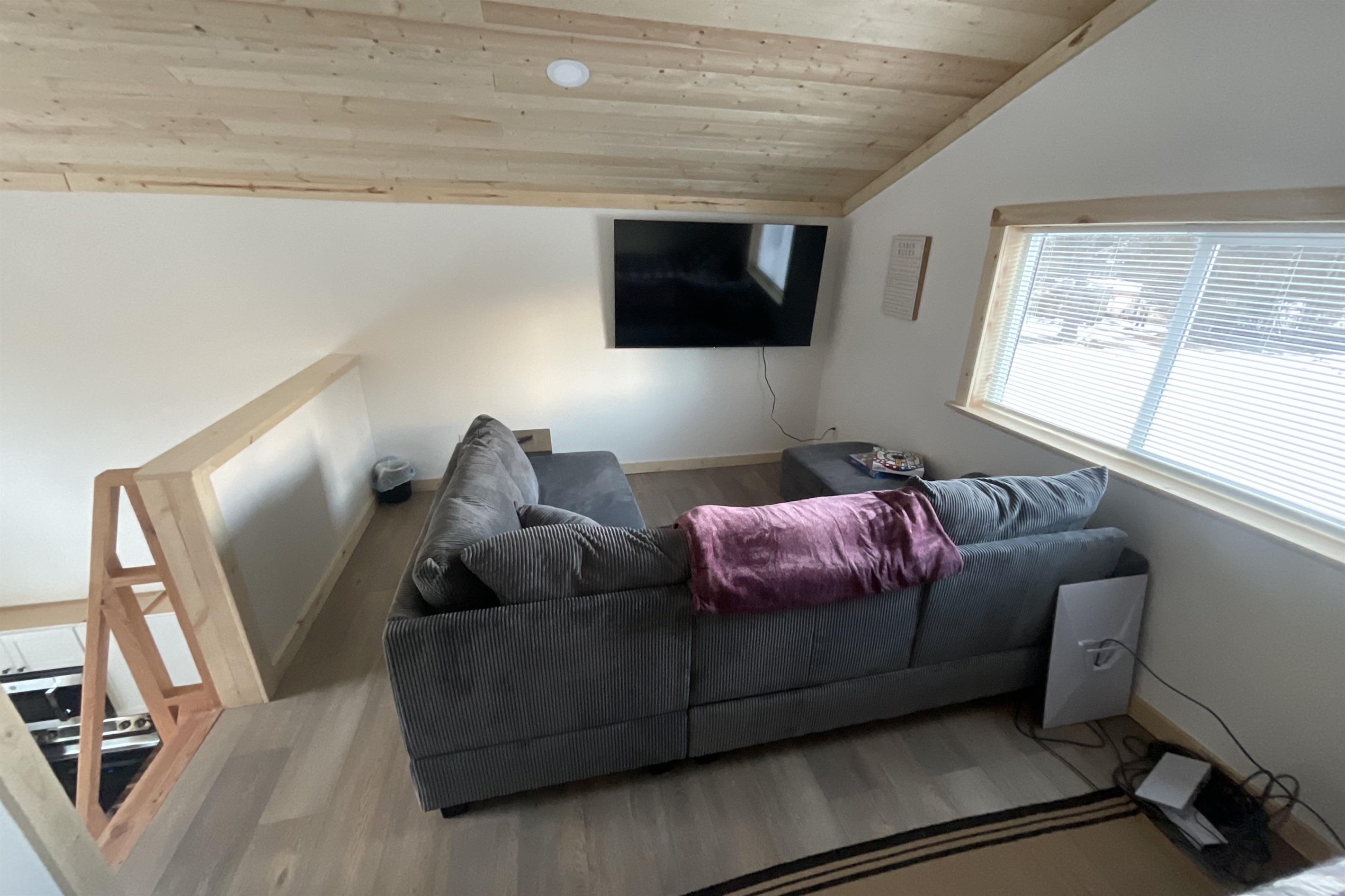 Loft living area - sectional sofa and big screen TV.