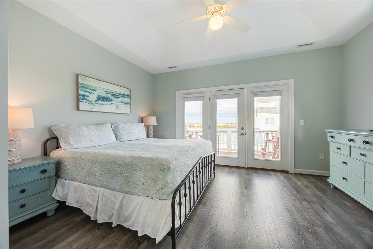 Spacious king bedroom opens to a private balcony—perfect for morning coffee or evening unwinding