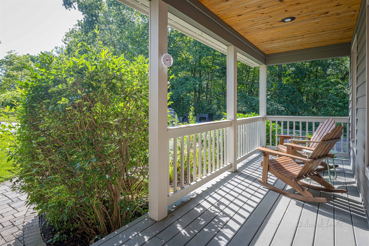 Welcoming front porch with two Adirondack chairs