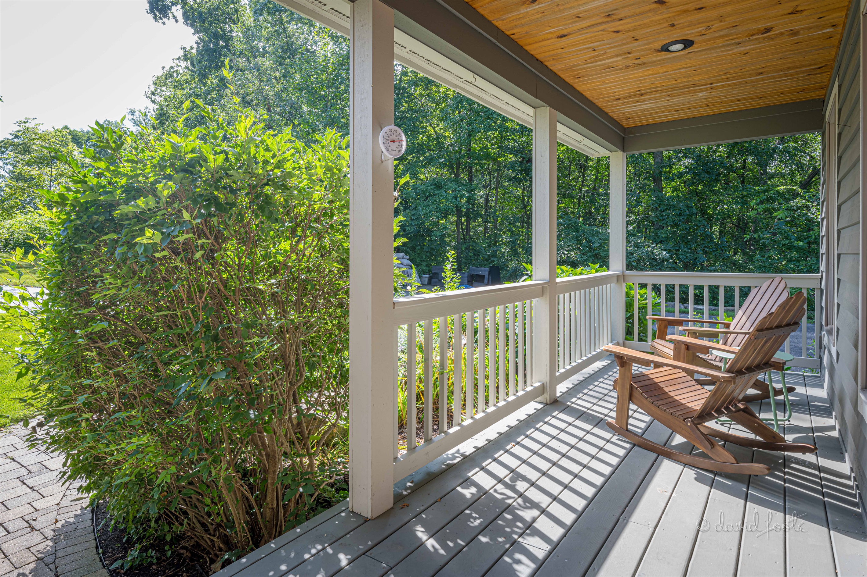 Welcoming front porch with two Adirondack chairs