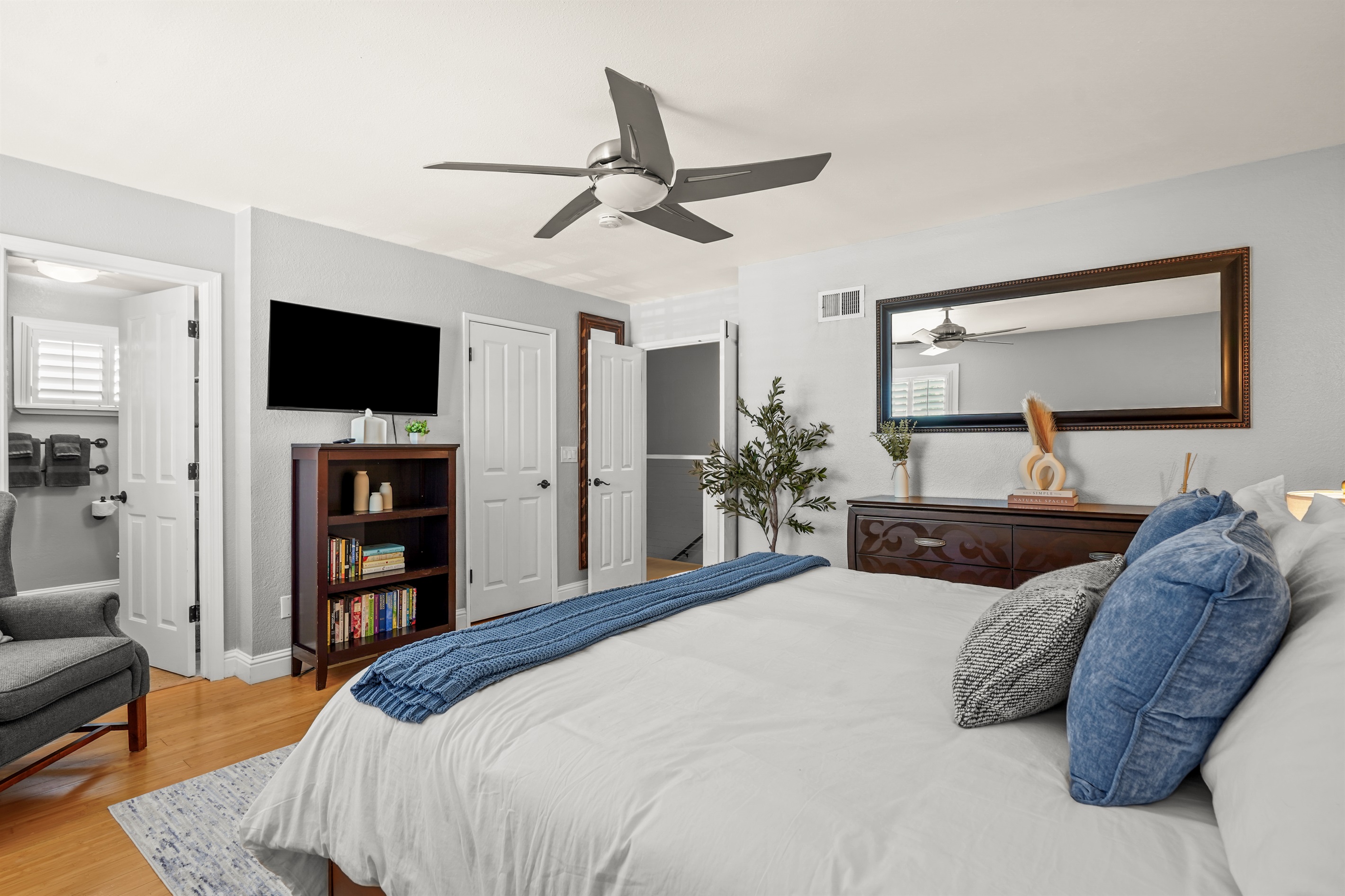 Spacious upstairs primary suite featuring a king bed and ensuite bathroom with dual sinks.