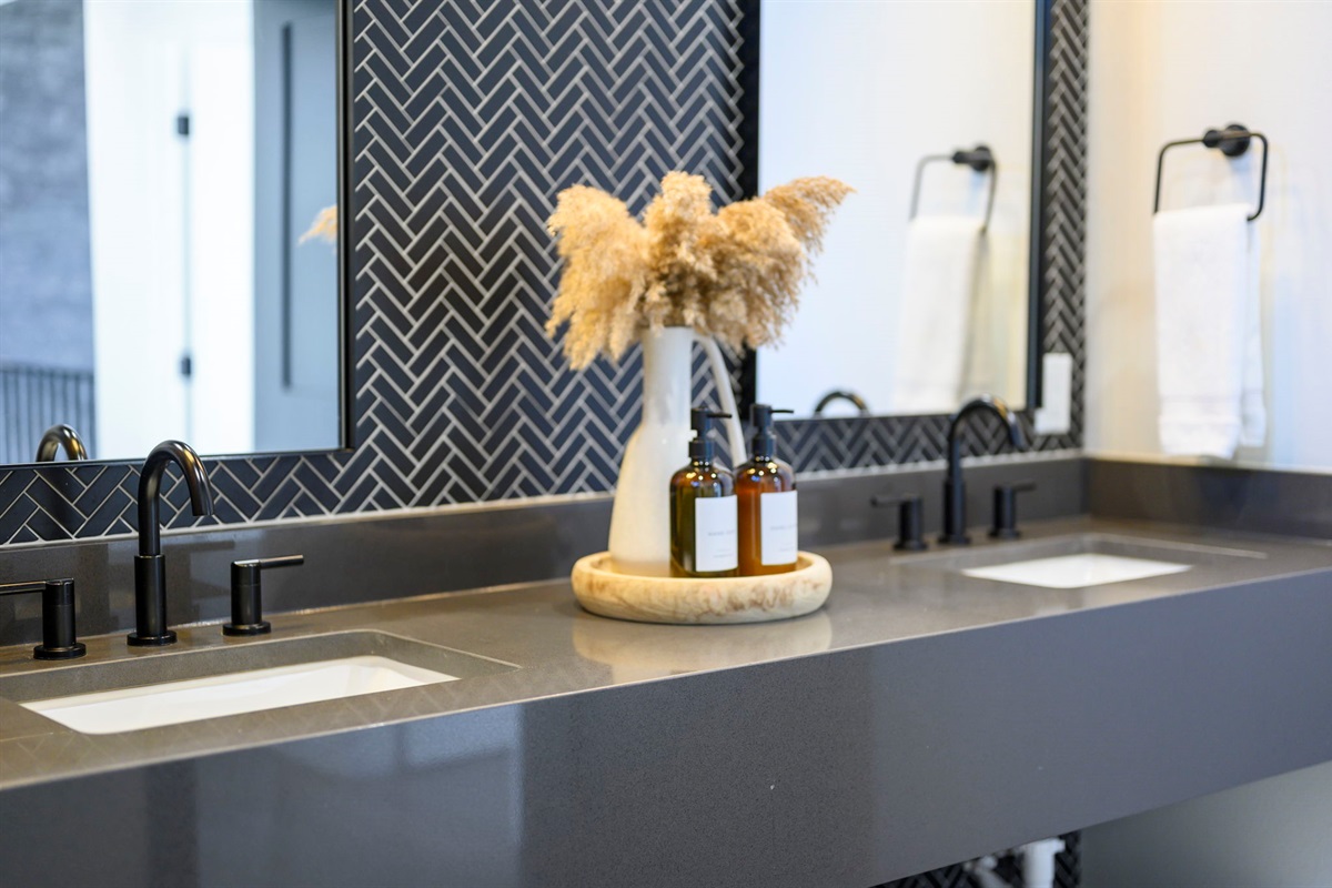 Semi-private bathroom for those staying in the Bunk room. This bathroom features modern teak finishes, stunning modern design, and an oversized rain shower with dual shower heads. 
