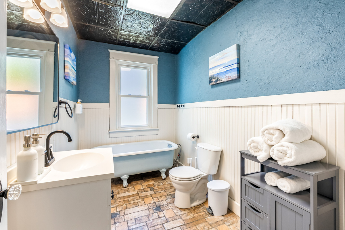 Convenient main-floor full bathroom serving the two main-level bedrooms. Features a classic, historic clawfoot tub. (Note: This bathroom features a tub only, no shower).