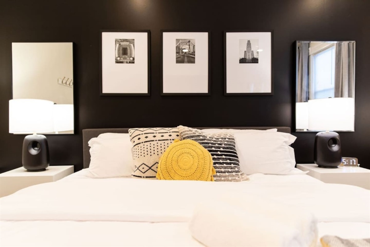 Spacious bedroom featuring a king bed, providing ample room for relaxation and comfort, perfect for a restful night's sleep.