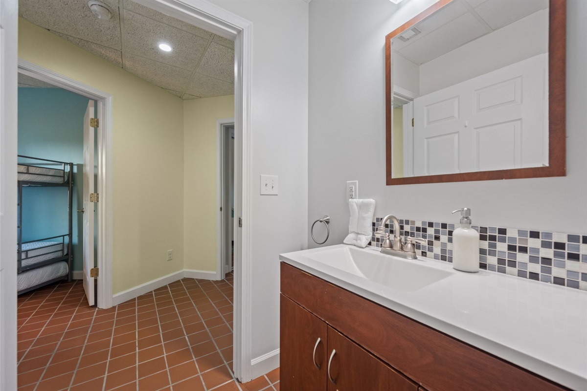 Hallway bathroom with modern vanity and easy access