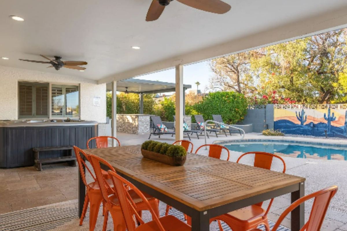 A shaded dining table seats the whole group right poolside, so meals never mean stepping away from the fun.