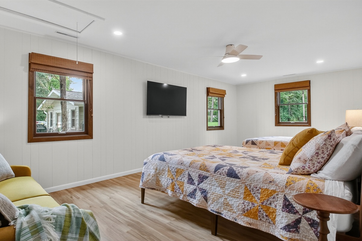 Two queen room with Roku TV and couch.