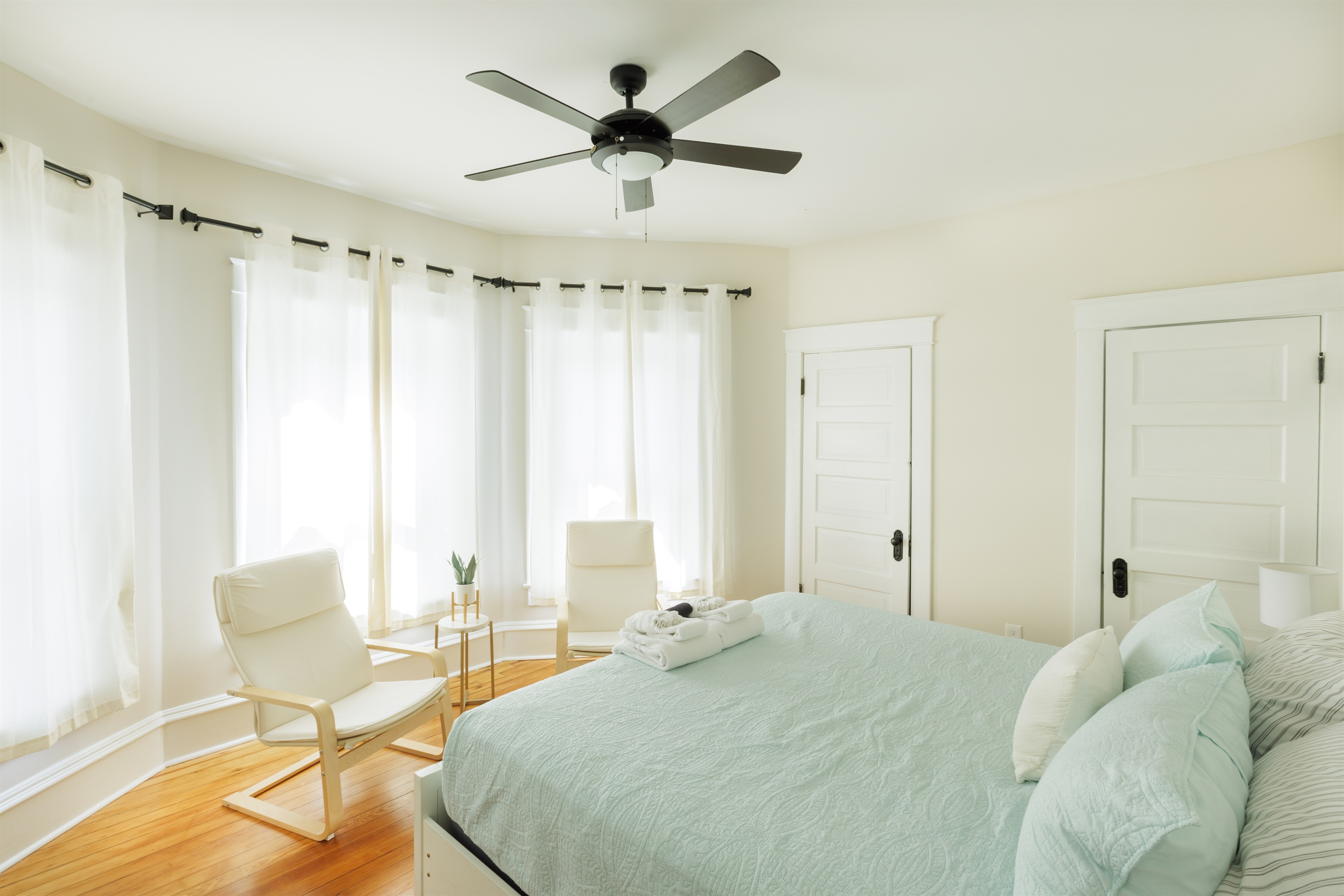 Large King Bedroom with extra seating, clothing storage.