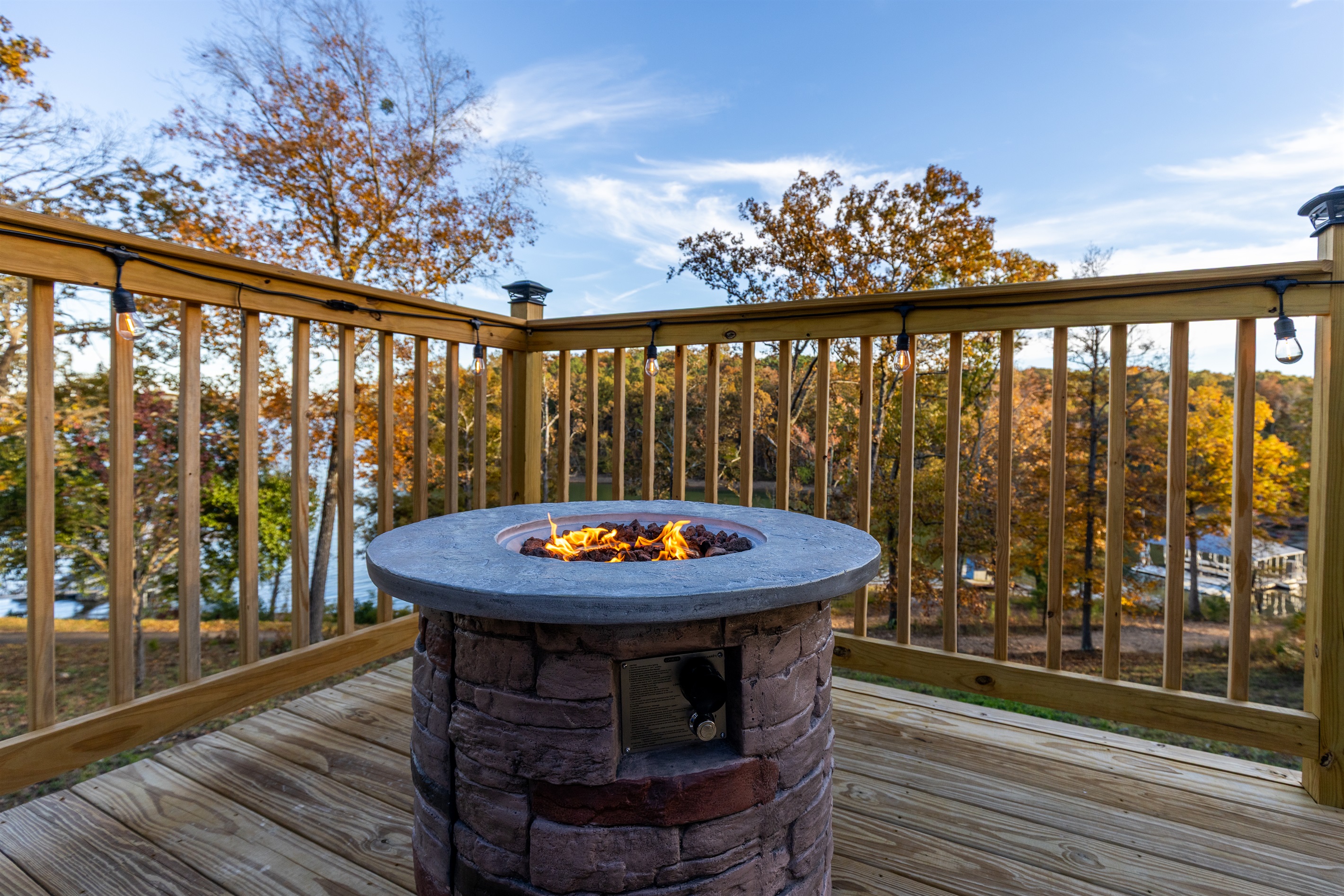 Cozy stone fire pit overlooking the lake — the perfect spot for sunset cocktails and stargazing