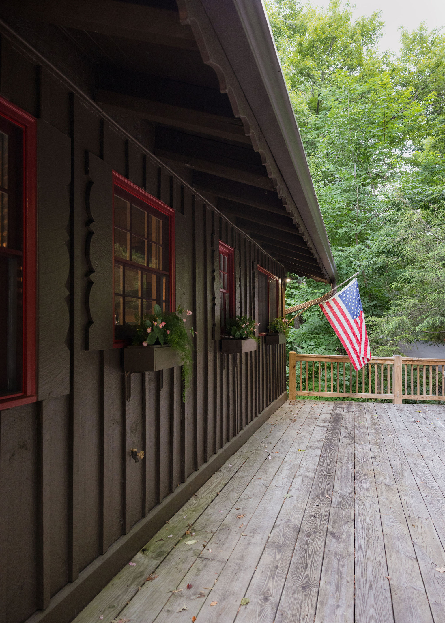 A warm welcome awaits, with seasonal flower boxes, our front porch flag, and a peaceful woodland setting.