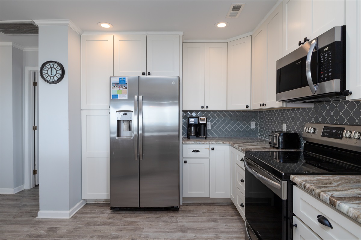 Fully equipped modern kitchen with white cabinetry