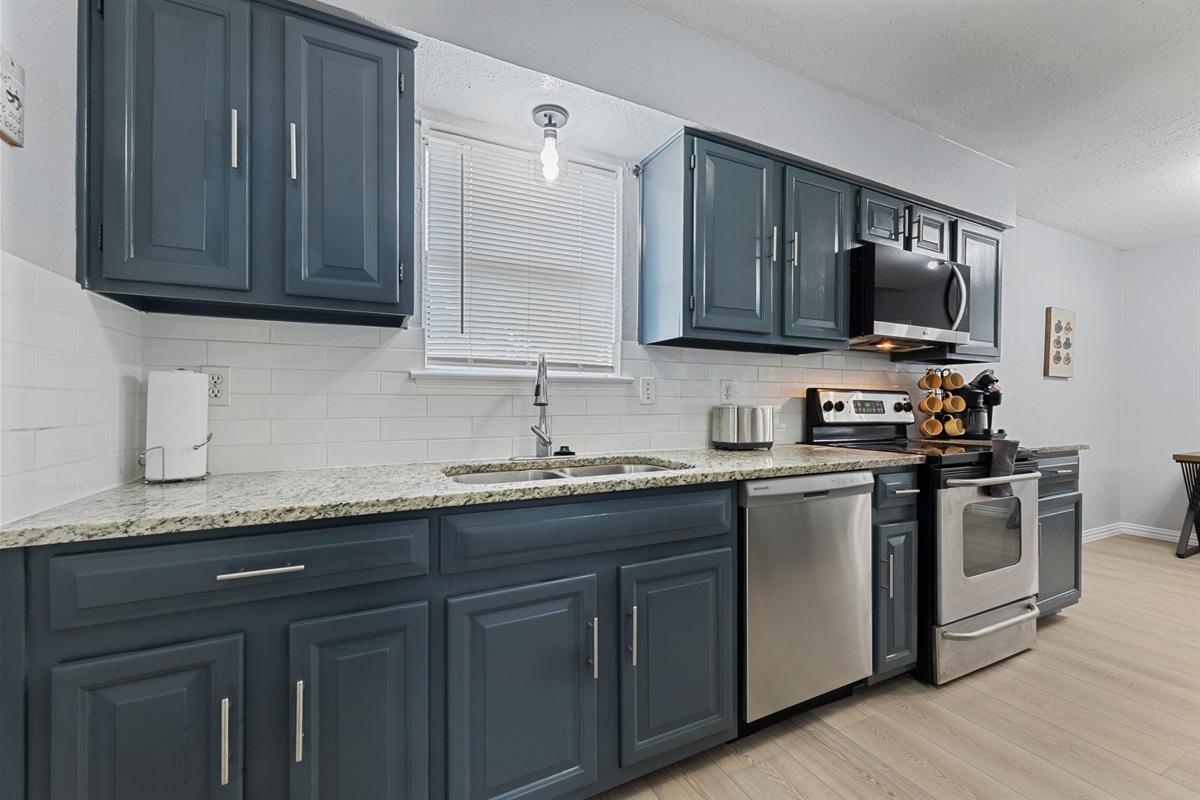 Stainless steel appliances including oven, microwave, and dishwasher