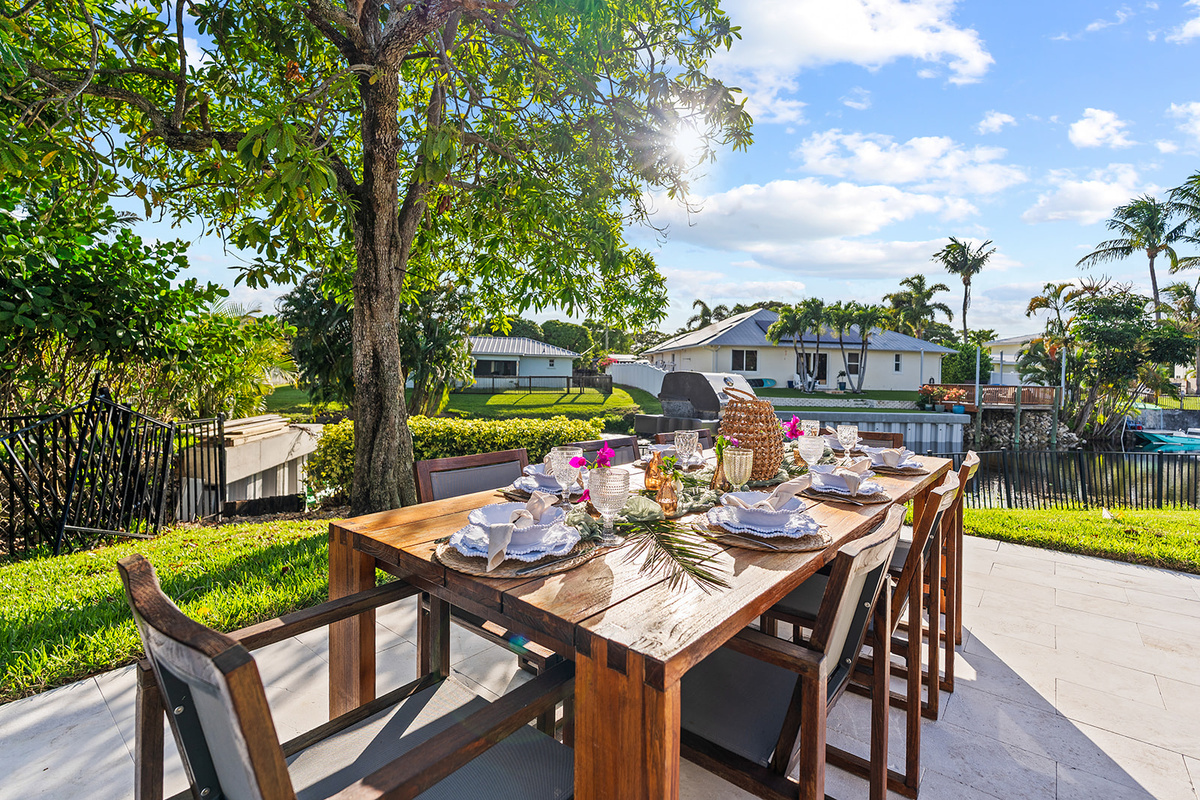 Dine beneath the shade of mature tropical trees while enjoying the peaceful waterfront atmosphere.