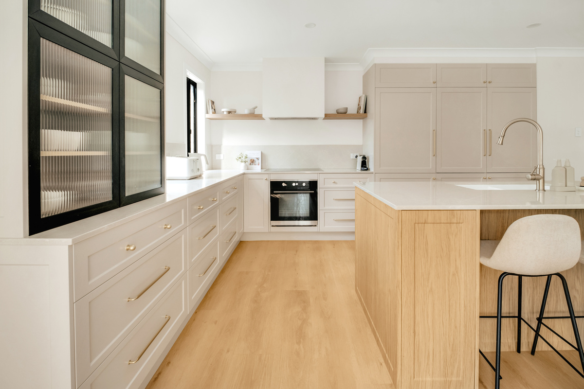 Tall storage, wide drawers and a central island give the kitchen practical space for longer stays and meal preparation.