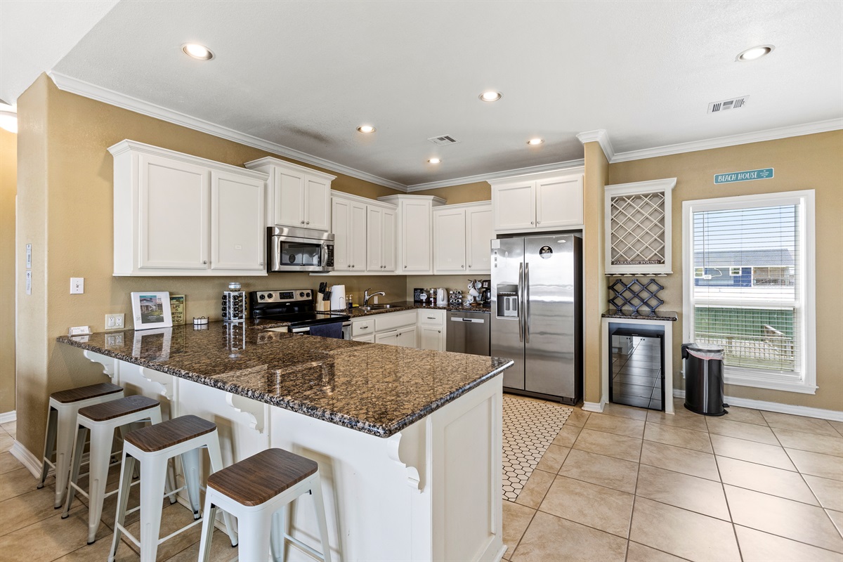 Four bar stools at the kitchen bar for extra seating