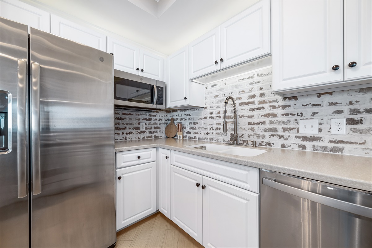 Modern kitchen essentials at your fingertips. This countertop setup offers everything you need for a quick breakfast or a relaxing cup of coffee.