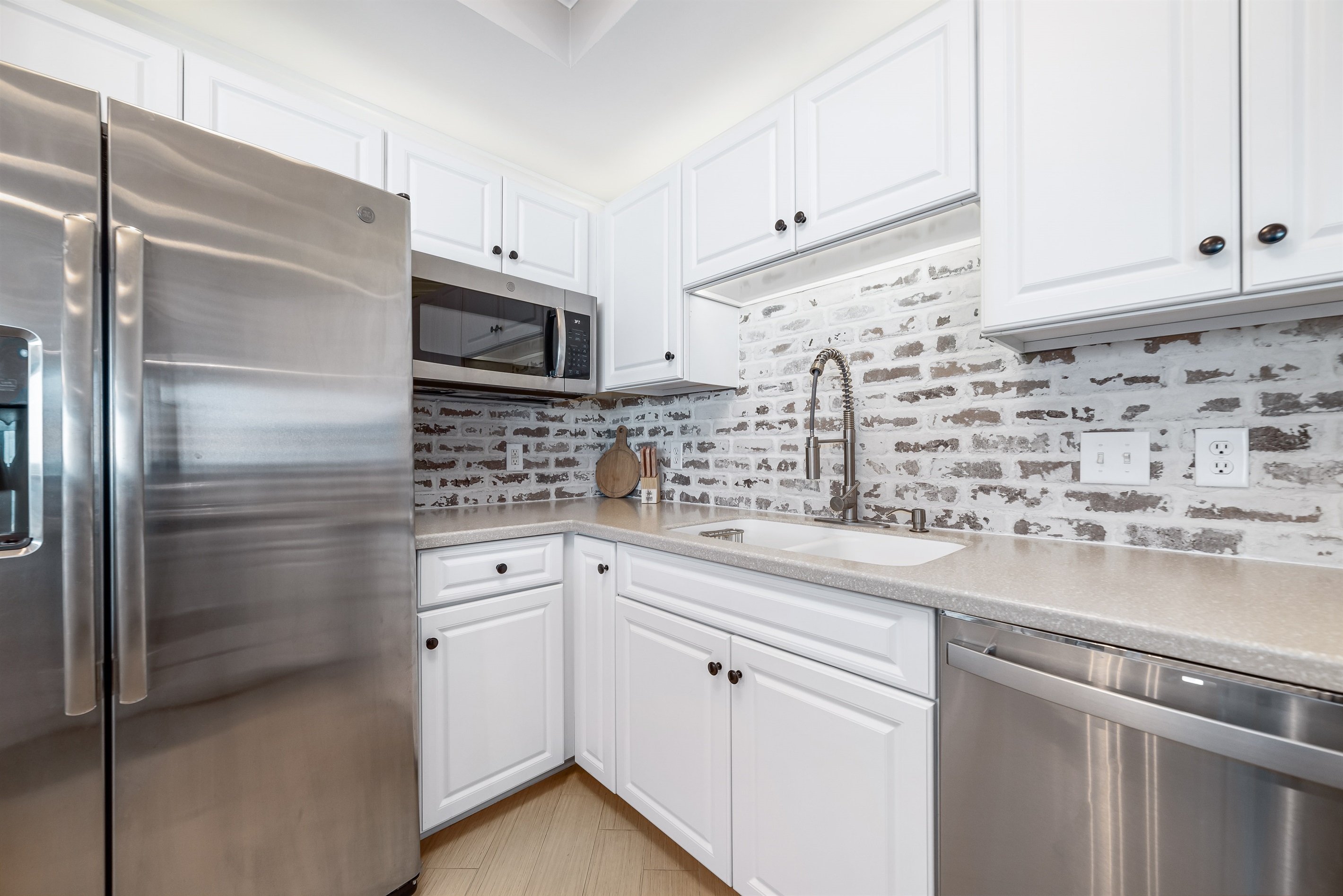 Modern kitchen essentials at your fingertips. This countertop setup offers everything you need for a quick breakfast or a relaxing cup of coffee.