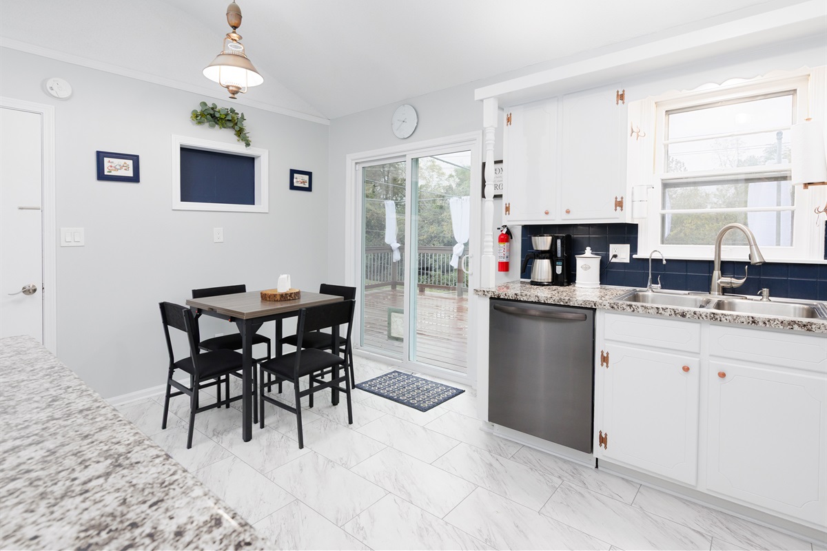 Eat-in kitchen dining area with expandable table seating up to six guests comfortably. Layout designed for easy meals, conversation, and entertaining.
