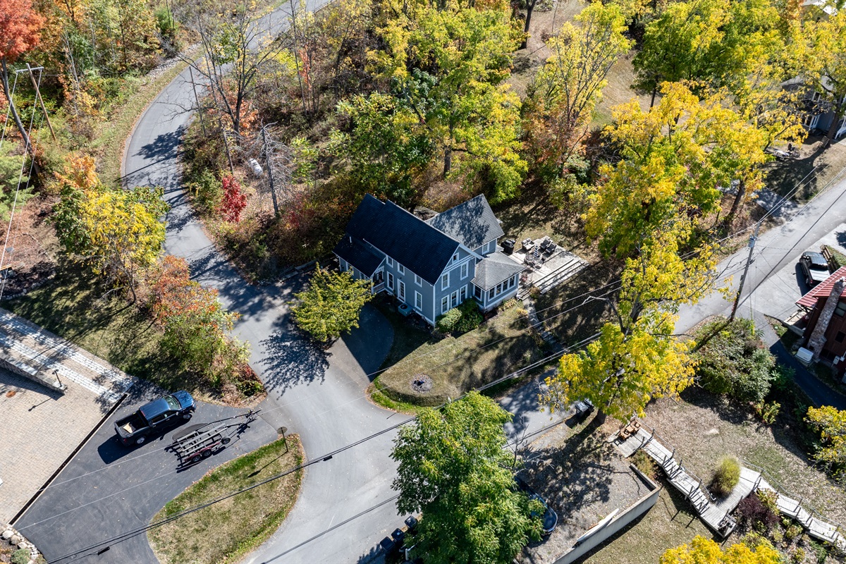 Peaceful residential road lined with trees and vibrant colors—autumn paradise near the lake