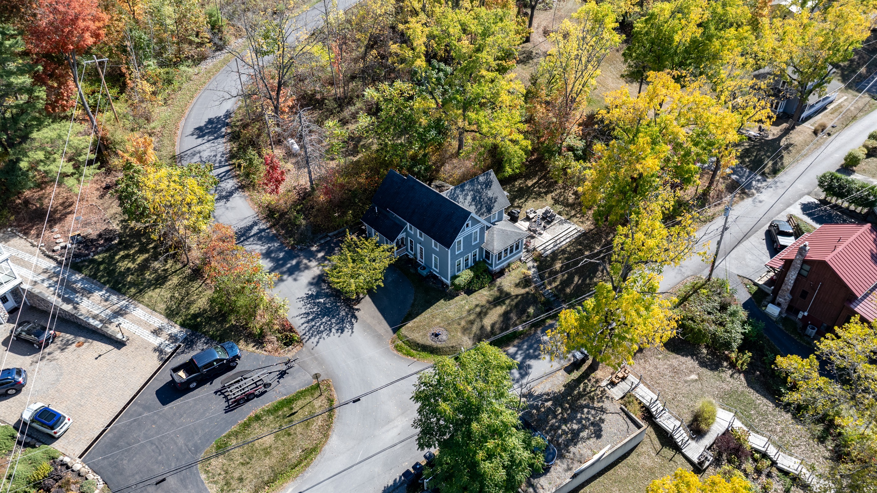 Peaceful residential road lined with trees and vibrant colors—autumn paradise near the lake