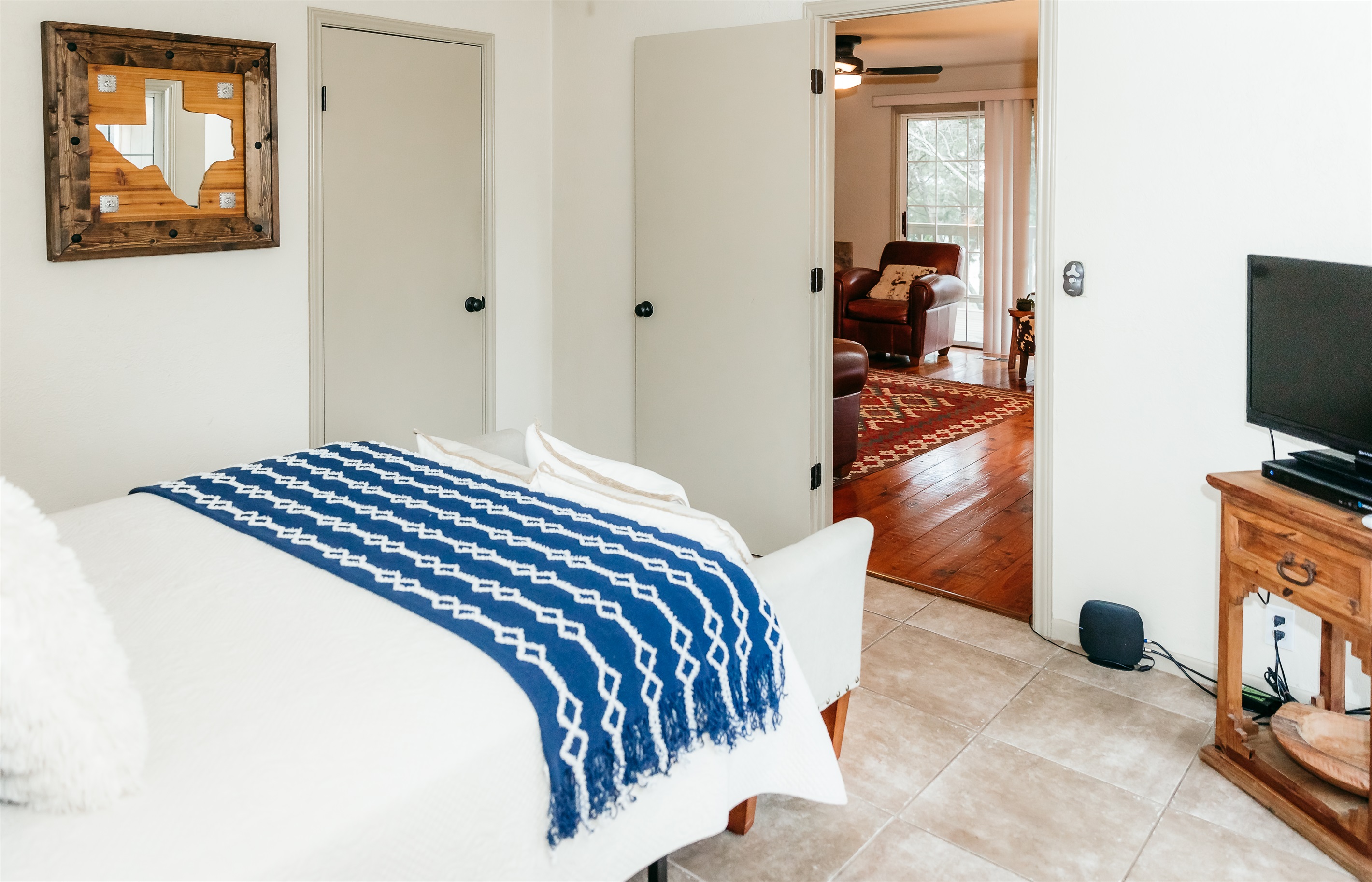 The downstairs bedroom connects to the living room and downstairs bathroom. TV is connected to DirectTVom