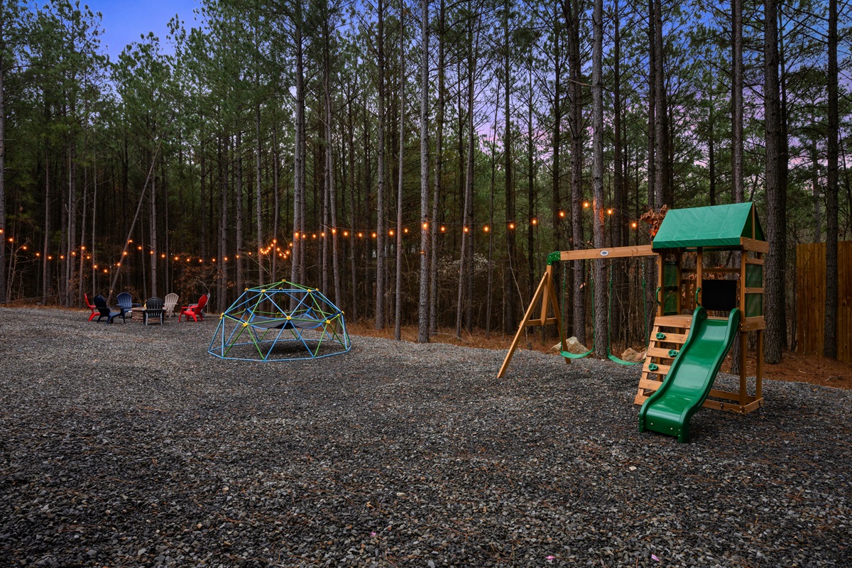 The spacious outdoor area offers plenty of room for yard games, exploring the trees, or simply enjoying time outside together.