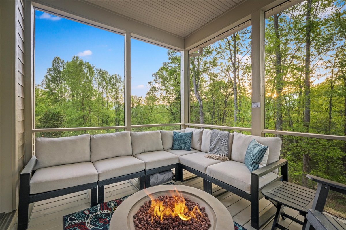 Start your day wrapped in a blanket by the fire, coffee in hand, as the sunrise filters through the forest. This cozy screened-in porch is the perfect place to watch the mountains wake up.
