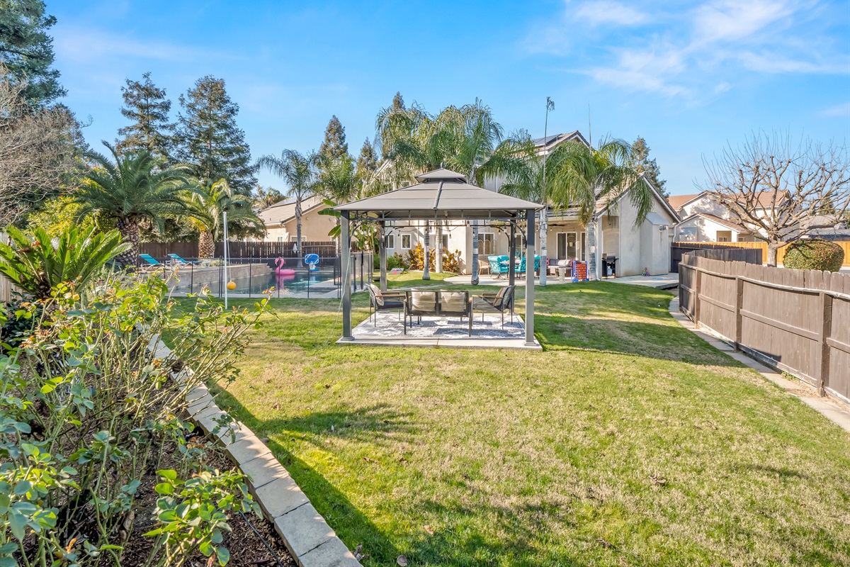 Thoughtfully designed layout includes pool, lounge gazebo, patio dining, and spacious lawn for a resort-style experience.