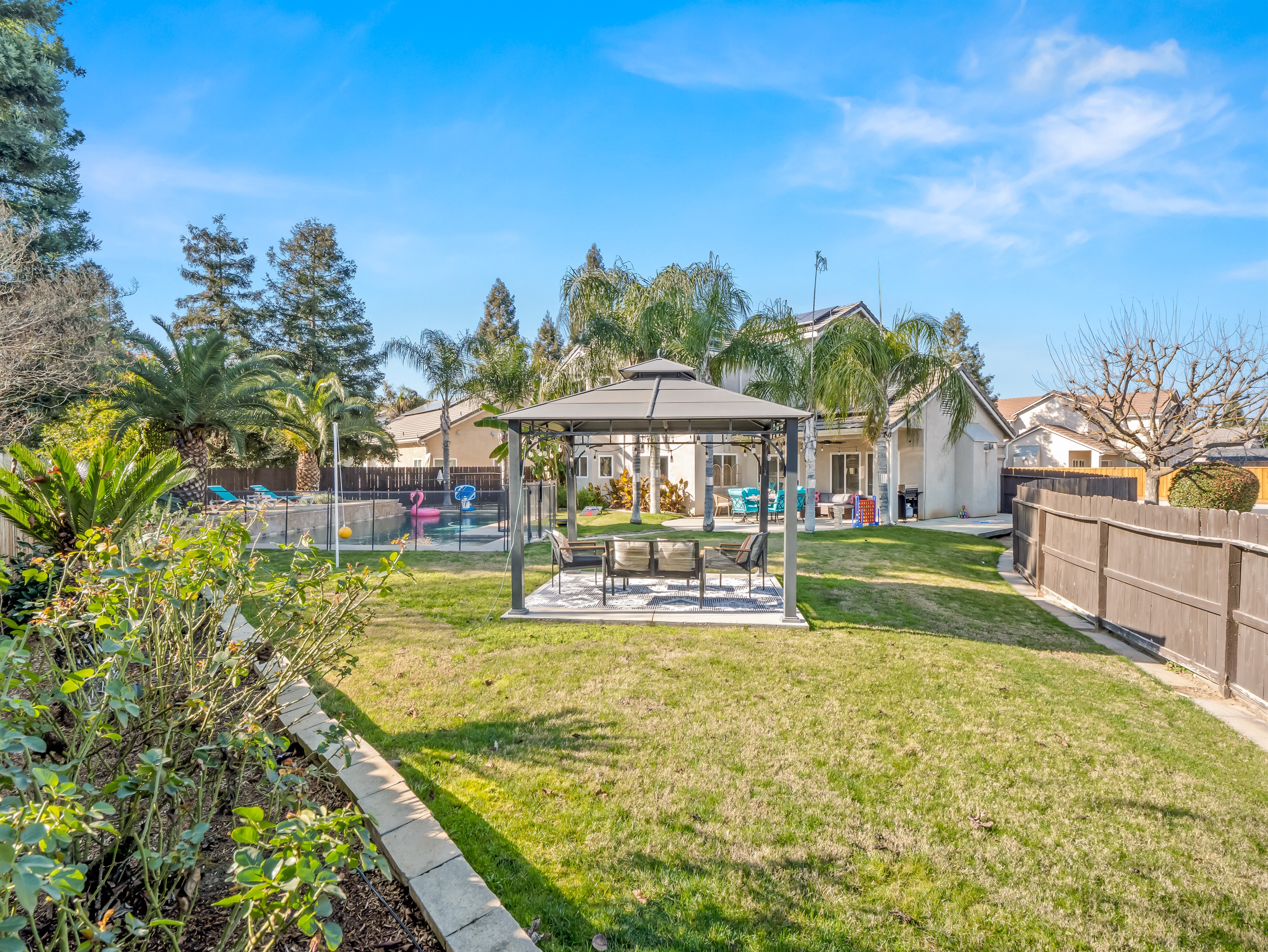 Thoughtfully designed layout includes pool, lounge gazebo, patio dining, and spacious lawn for a resort-style experience.