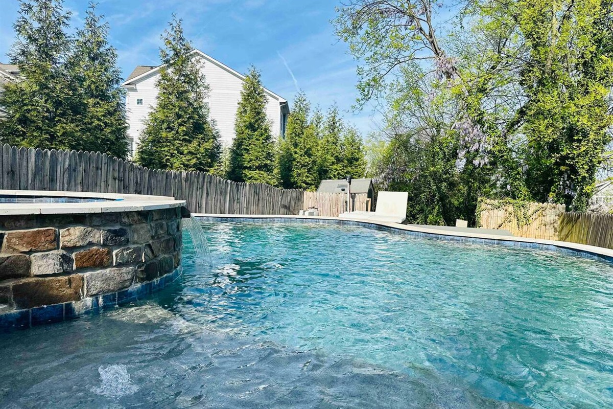 The salt water pool gets plenty of overhead sun and has a waterfall from the hot tub! And one of our favorite things about this backyard is the BIRDS. The birds tend to chirp throughout the day, making this a nature oasis, too.