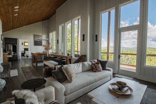 Living Room | Open-concept design with vaulted wood ceilings and panoramic views