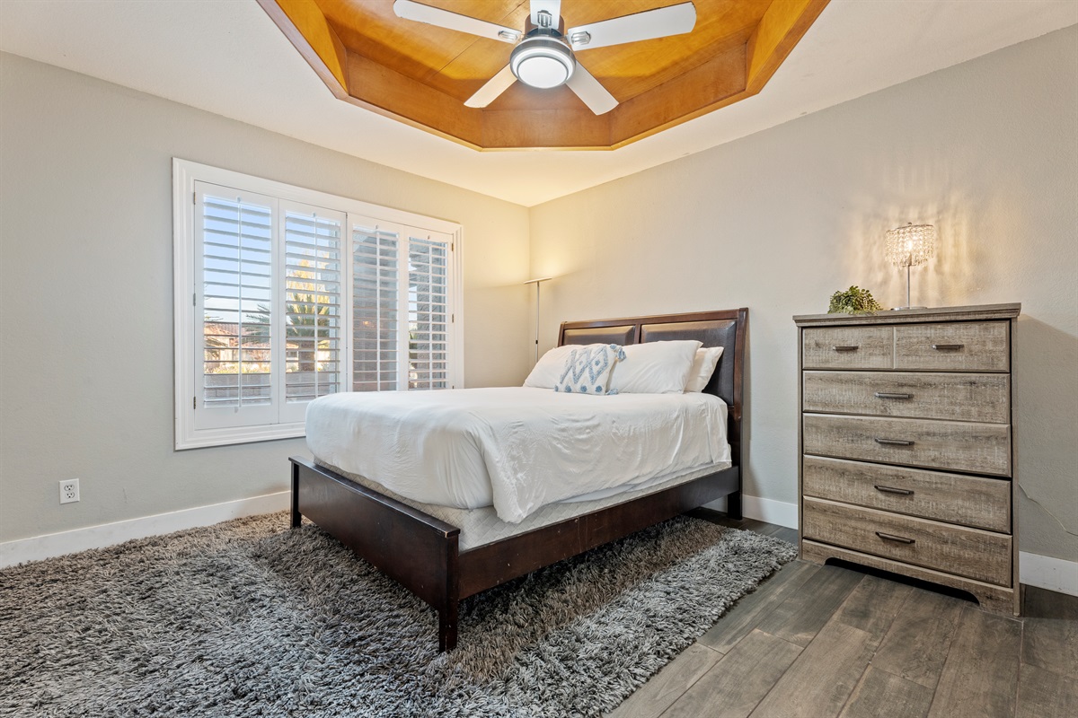Fresh and functional, the laundry room pairs charming wallpaper with updated appliances and access to the outdoors.