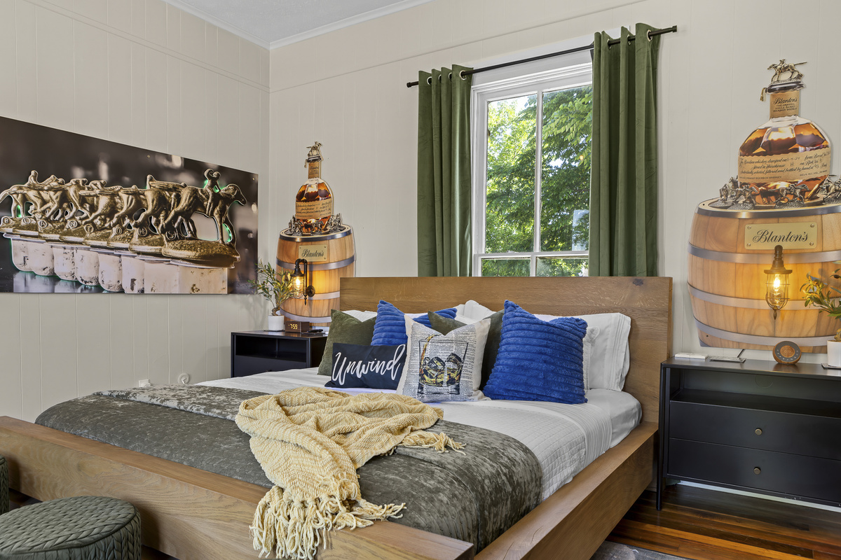 The Blanton's Room brings bourbon-bar energy to a king bed, fireplace, Netflix, and horse racing art throughout.