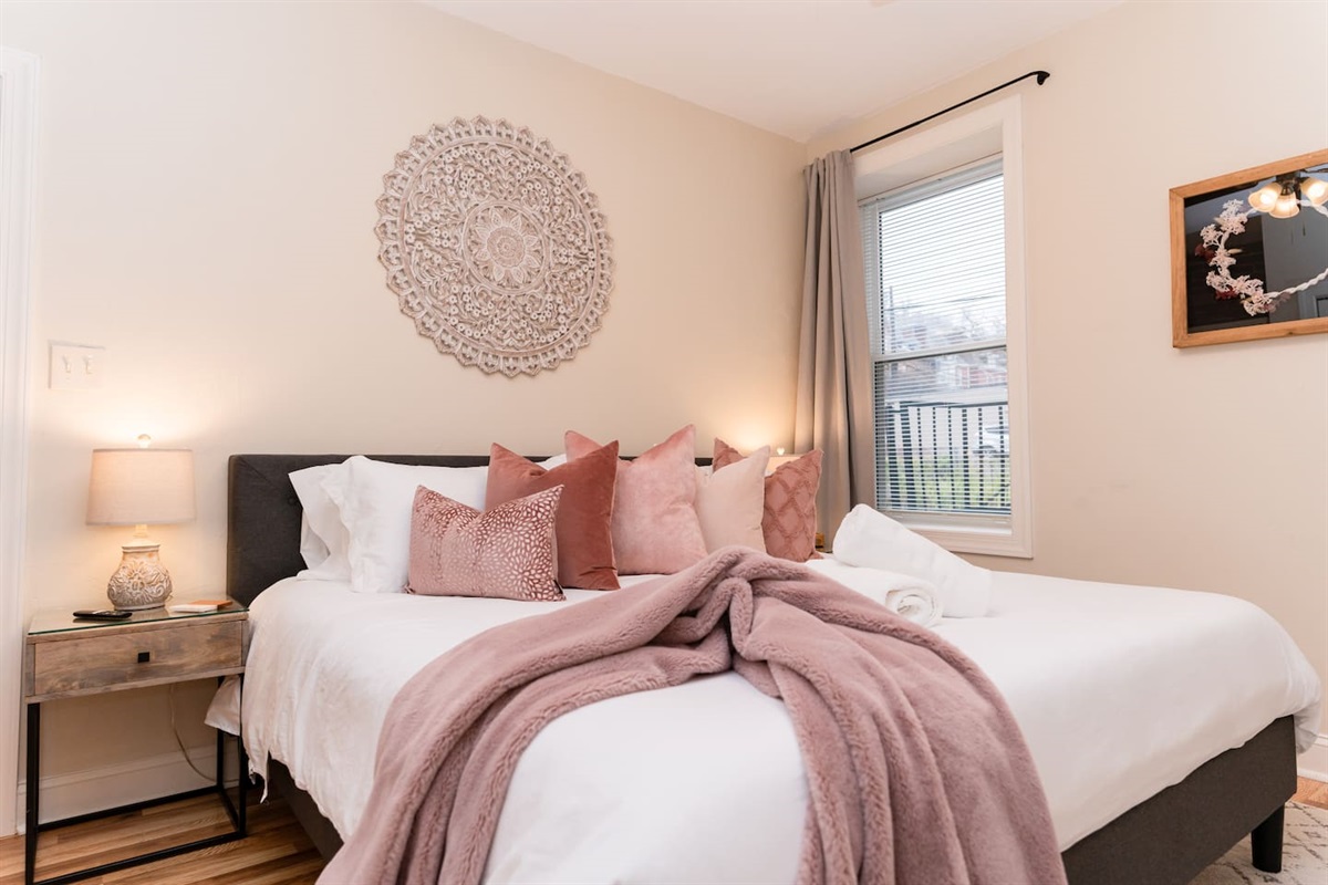 King-sized bedroom with a side window, offering plenty of natural light and comfort.