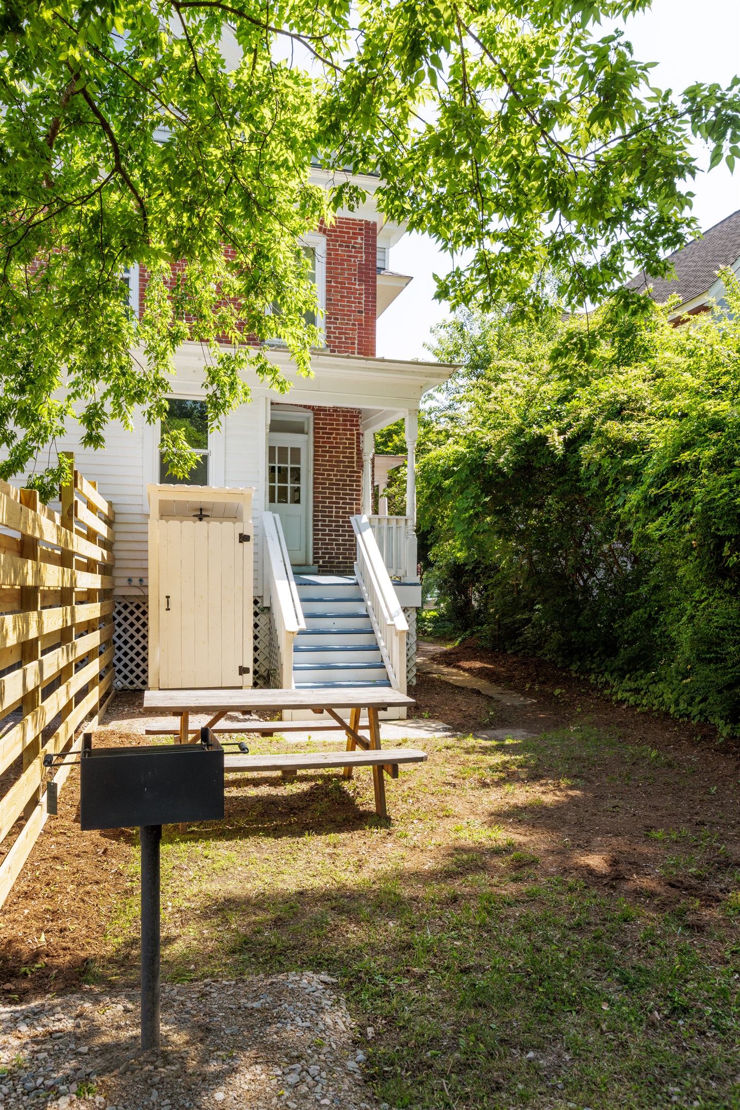 Shared backyard offers additional parking. A BBQ grill and outdoor seating have been recently installed behind the house on each side as well.